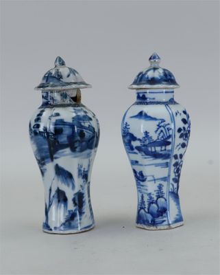 une paire de vases bleus et blancs avec couvercles, posés sur une surface blanche