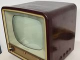 a small television sitting on top of a white table