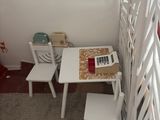 a small table and two chairs in the corner of a room