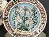 a plate with a picture of a tree on it next to other plates