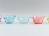 a set of six multicolored glass vases sitting on top of each other