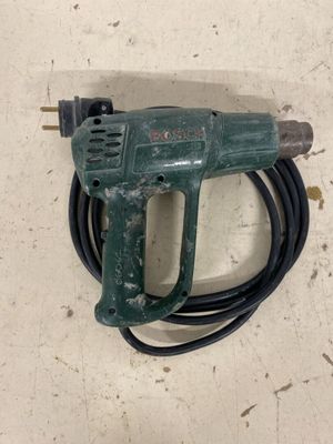 a green cord attached to a cord with a drill