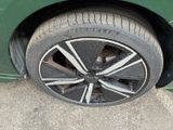 a close up of a tire on a green car