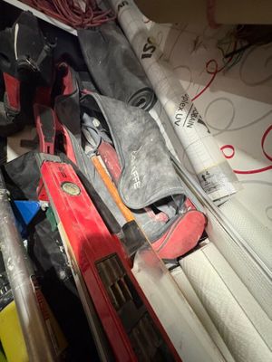 a pile of skis and ski poles sitting on a table