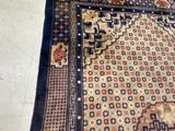 a cat that is sitting on a rug on the floor