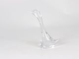 a clear glass sculpture of a bird on a white surface