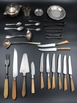 many different types of knives and spoons on the table
