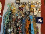 a white box filled with lots of jewelry on the floor
