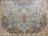 an image of a blue rug with a floral design on it