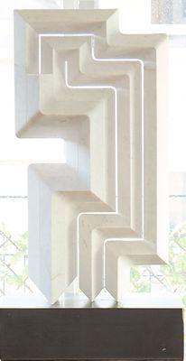 a white sculpture on a table in front of a window