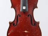 an old violin with a bow hanging from it ' s back
