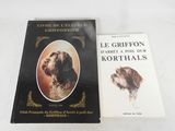 deux livres posés sur une table blanche, avec un chien et une photo de chien