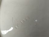 underside view of a white porcelain bowl with the word ' o ' written on it