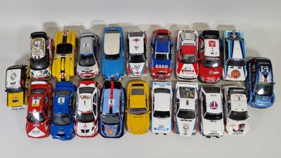 a lot of toy cars that are lined up on a table