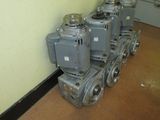a long line of valves lined up against a wall