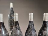 several bottles of wine are lined up on a table