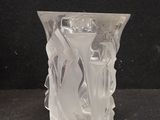 a clear glass vase with a flower inside of it