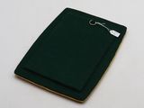 a small book with a green cover on a white table