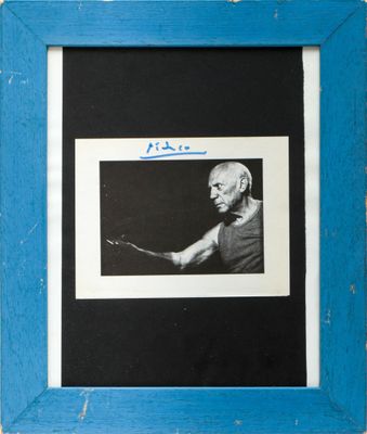 a black and white photo of a man holding a tennis racquet
