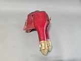 a red shoe with a gold heel on it