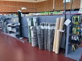 many rolls of fabric on the shelves in the store