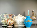 three vases and a teapot sitting on a table