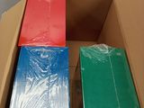 a cardboard box filled with different colored sheets of paper