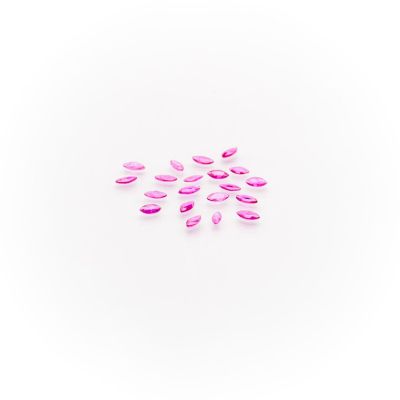 a group of pink petals on a white surface