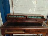 a wooden desk with two drawers on top of it