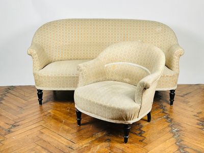 un canapé et un fauteuil posés sur un parquet