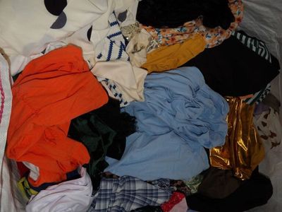 a pile of clothes in a plastic bag on the floor
