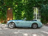 a blue sports car parked in front of a building