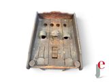 an old wooden box with holes in it on a white surface