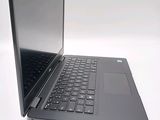 a laptop that is open on a white surface
