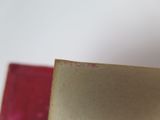 a close up of a book with a red cover