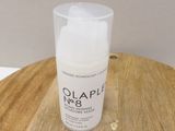 a bottle of olaple next to a wooden table
