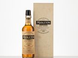 a bottle of whisky sitting next to a cardboard box on a table