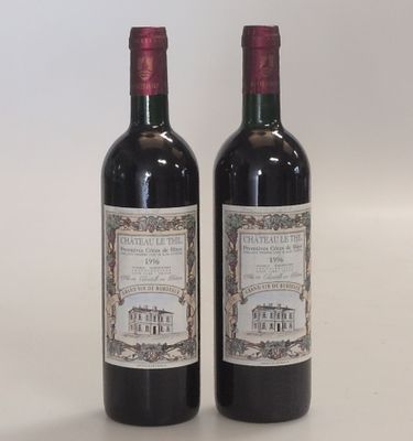two bottles of red wine sitting next to each other on a table