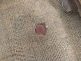 a small red object on the floor of a living room