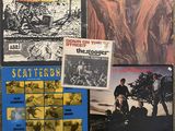 a group of various vinyl records on a table