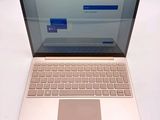 a laptop computer sitting on a table with a keyboard on it