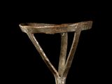 a small metal object that is sitting on a black surface