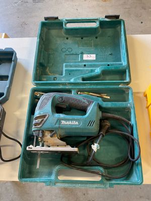 an image of a tool box with a cord saw and other tools