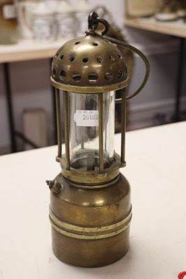 a small brass lantern sitting on a white table