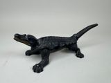black alligator figurine on a white background