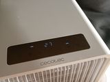 a white air purifier sitting on top of a table