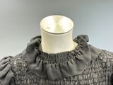 grey dress with ruffles and collar neckline on mannequin mannequin mannequin mannequin mannequin mannequin mannequin
