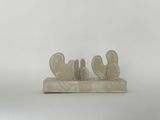 a sculpture of three birds sitting on top of a marble block