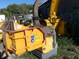 a yellow machine that is sitting in the grass