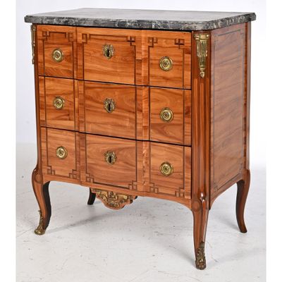 a wooden chest of drawers with a marble top